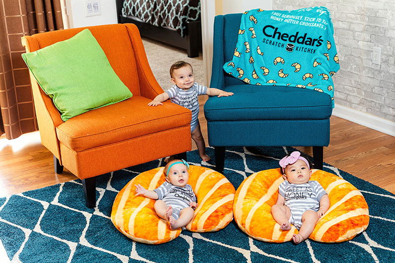 Babies will love their Cheddar's croissant-themed support pillows, onesies and baby blankets.