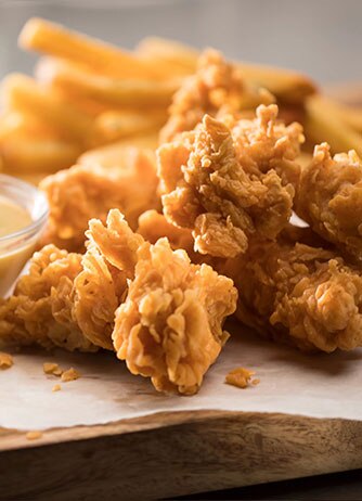 Cheddar's Chicken Tenders, served with a side of sauce.