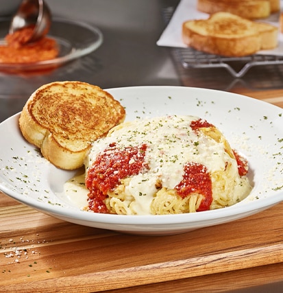 Come to Cheddar's to enjoy our famous Spasagna! Topped with homemade marinara and Alfredo. Order today!