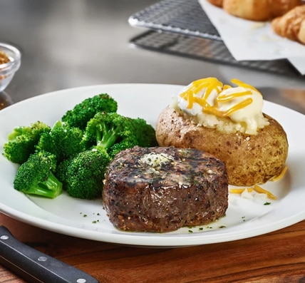 Cheddar's delicious 7-ounce filet next to a loaded baked potato and a side of broccoli.